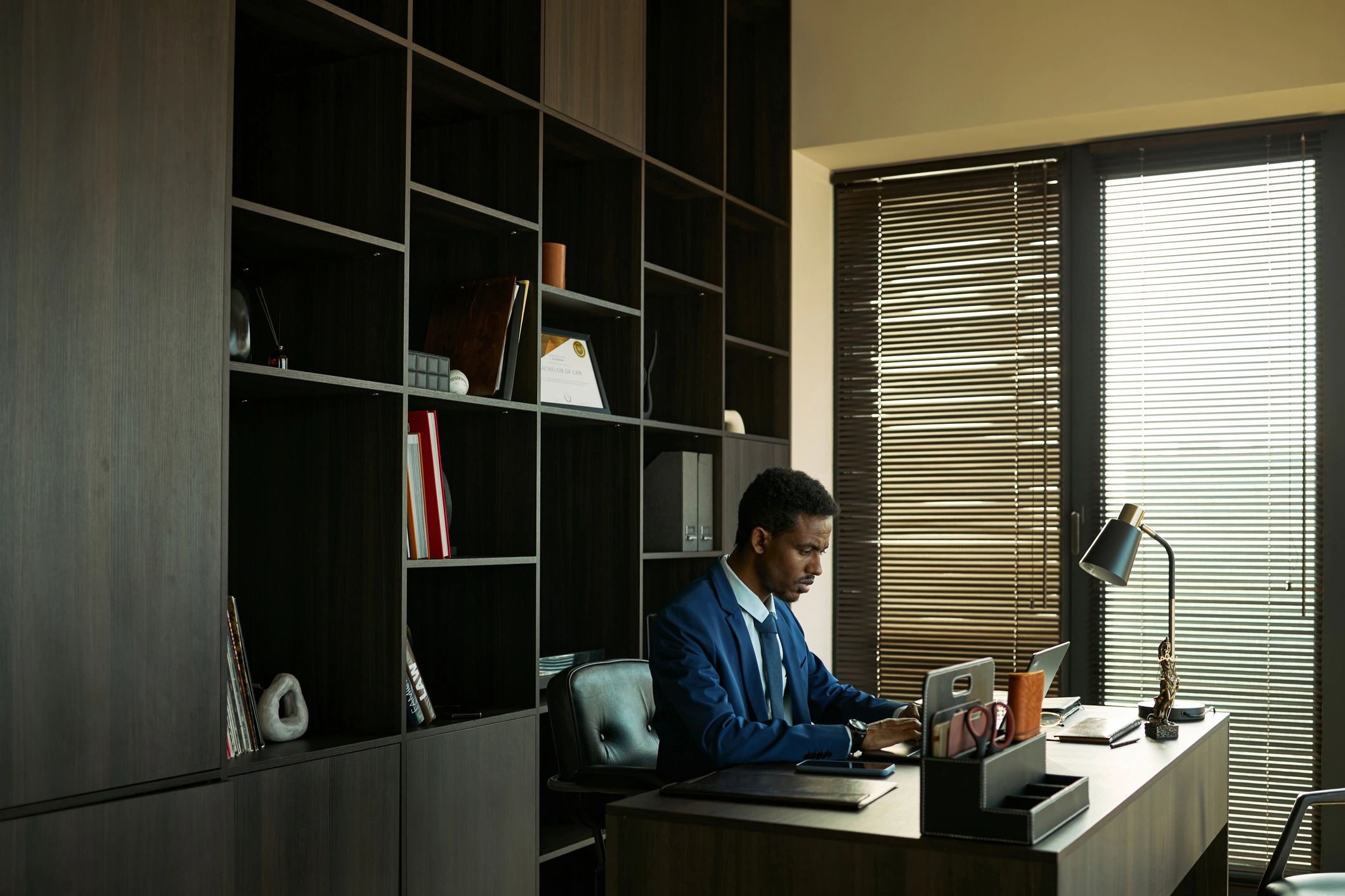 Consultant reviewing plans at a desk with focused attention